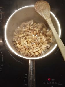 champignons de paris en train de cuire dans une casserole