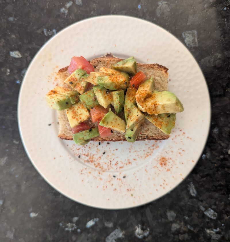 entrée tartine avocat tomates sur une asseitte blanche